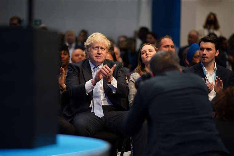 Prime Minister Boris Johnson applauds as Chancellor Rishi Sunak speaks at the Conservative Party conference in Manchester (Peter Byrne/PA)