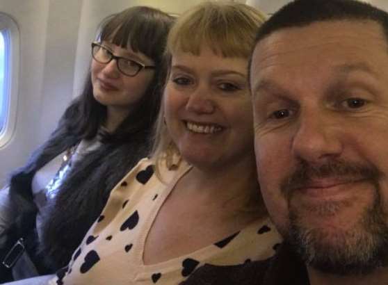 Claire Sharp with her daughter Faye and her current husband Lee on the flight to Perugia in Italy. Picture: SWNS