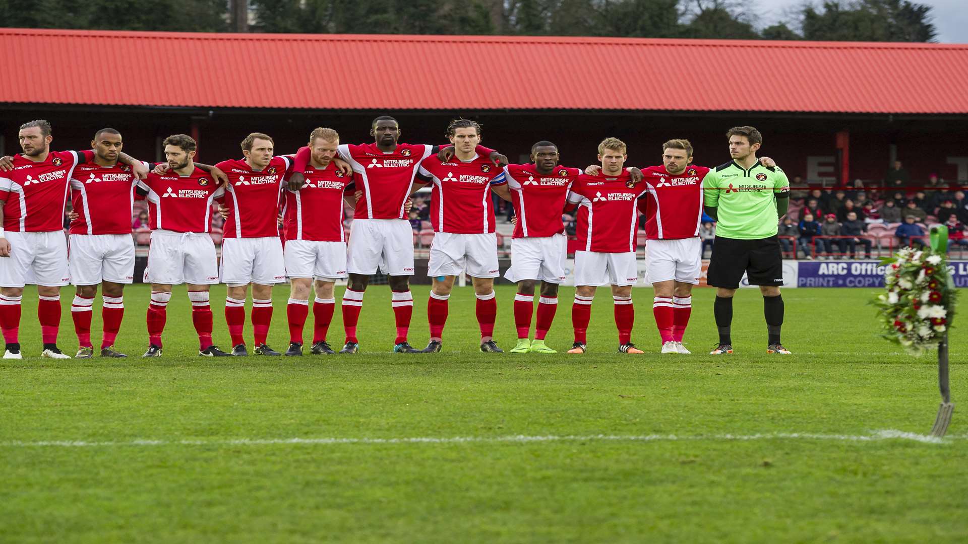 Ebbsfleet's players observe a minute's silence for groundsman Peter Norton Picture: Andy Payton