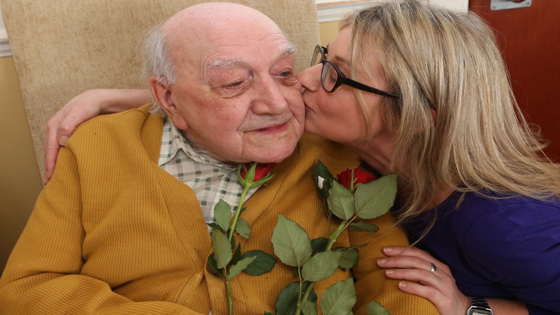 George Ridgewell, 93, gets a cheeky kiss from area manager Nicola Palladino. Picture: John Westhrop