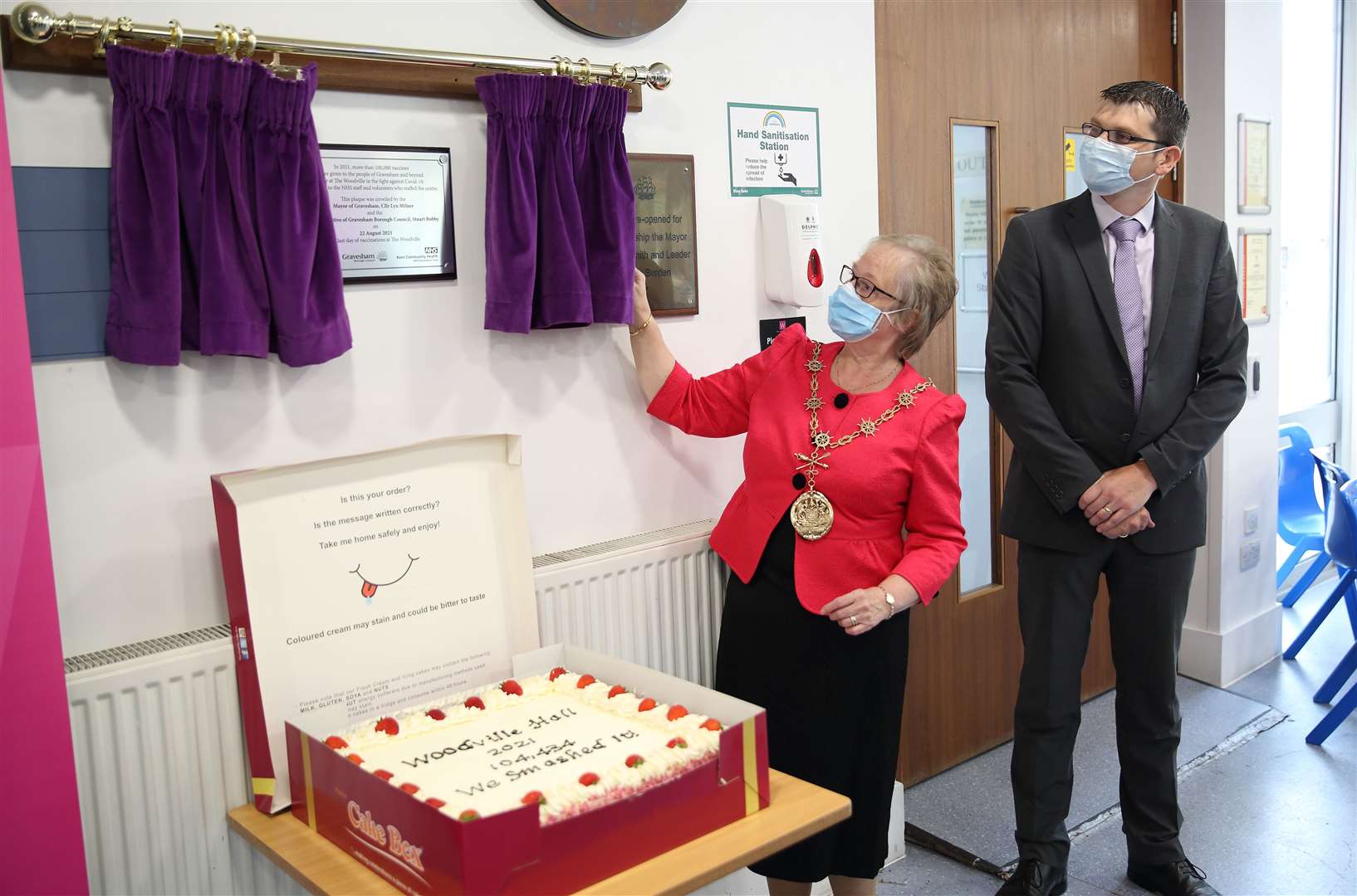 The Mayor of Gravesham, Cllr Lyn Milner, unveils the plaque commemorating The Woodville’s role in the Covid-19 vaccination programme, watched by Stuart Bobby, the chief executive of Gravesham Borough Council. Picture: Gravesham council