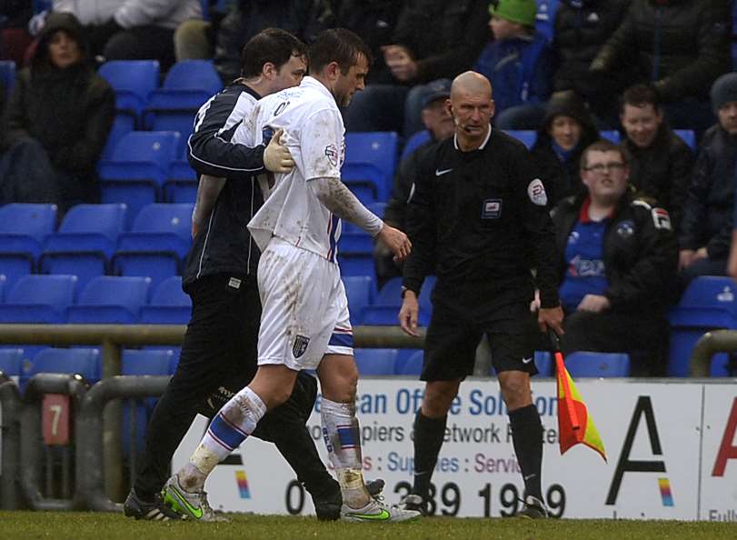 Gillingham captain Doug Loft goes off injured at Oldham Picture: Barry Goodwin