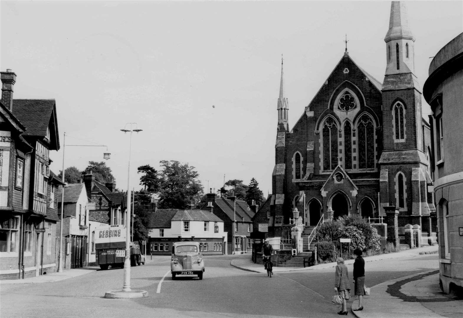 This view of Wincheap Green, Canterbury, from autumn 1961 looks along Pin Hill from where Wincheap roundabout is today. The Castle Hotel (left) was pulled down in 1963 and most of the buildings from left to centre were demolished to make way for the ring-road within a few years. St Andrew's Presbyterian Church was pulled down in 1973