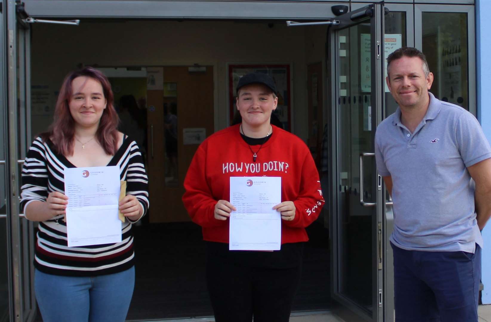 A level twin sisters Emily and Grace Vallance with principal Simon Smith. Picture: Goodwin Academy