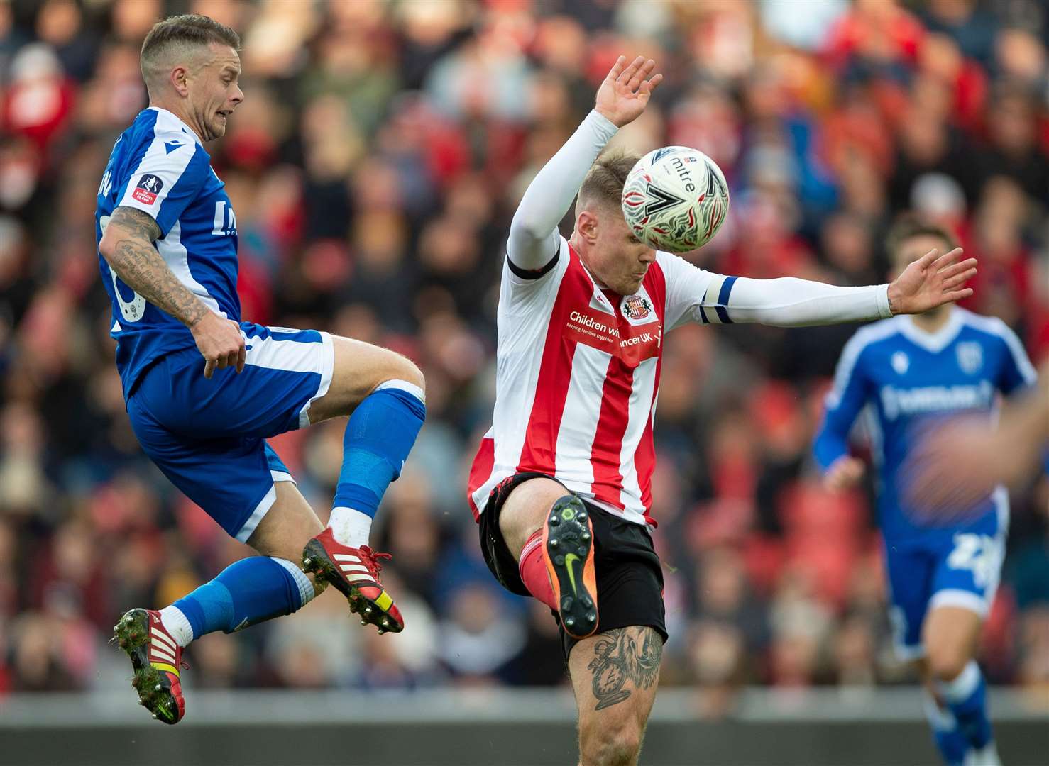 Mark Byrne challenges with Max Power in last weekend's FA Cup match at Sunderland