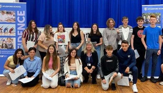 Students from Aylesford School celebrate their GCSE results with head teacher Tanya Kelvie