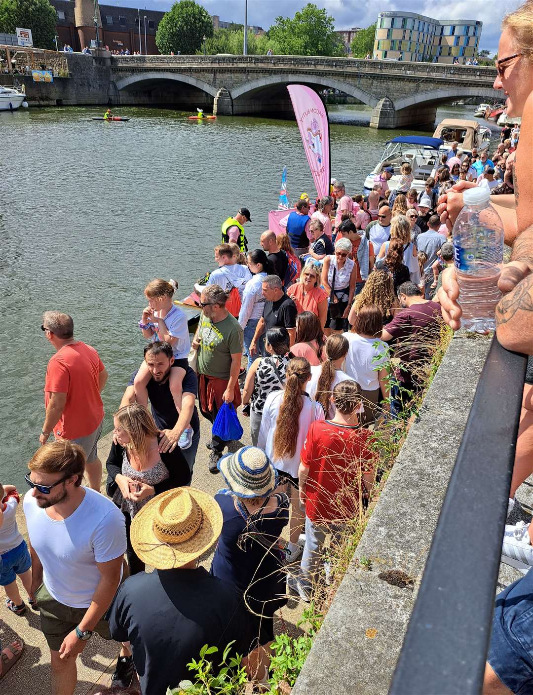 Crowds line the riverbank