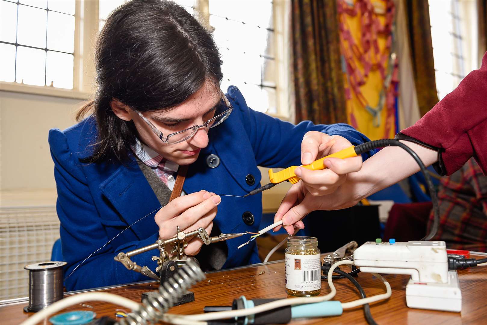 June Sandy repairing a soldering iron