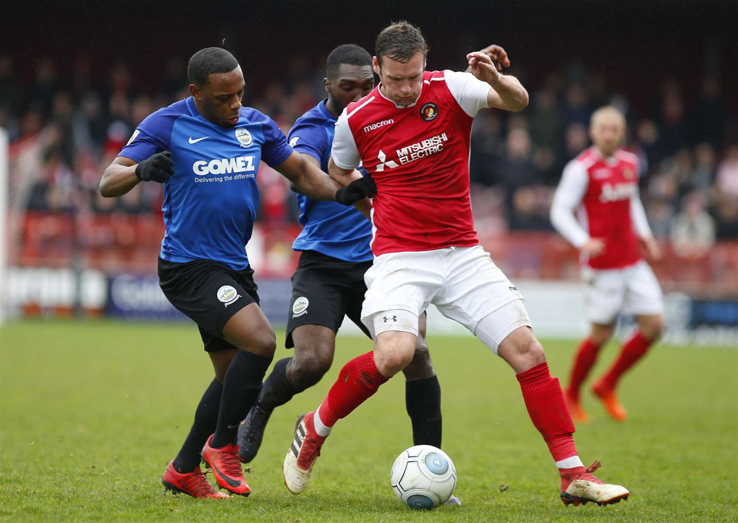 Andy Drury holds off two Dover players during Ebbsfleet's win on Easter Monday Picture: Andy Jones