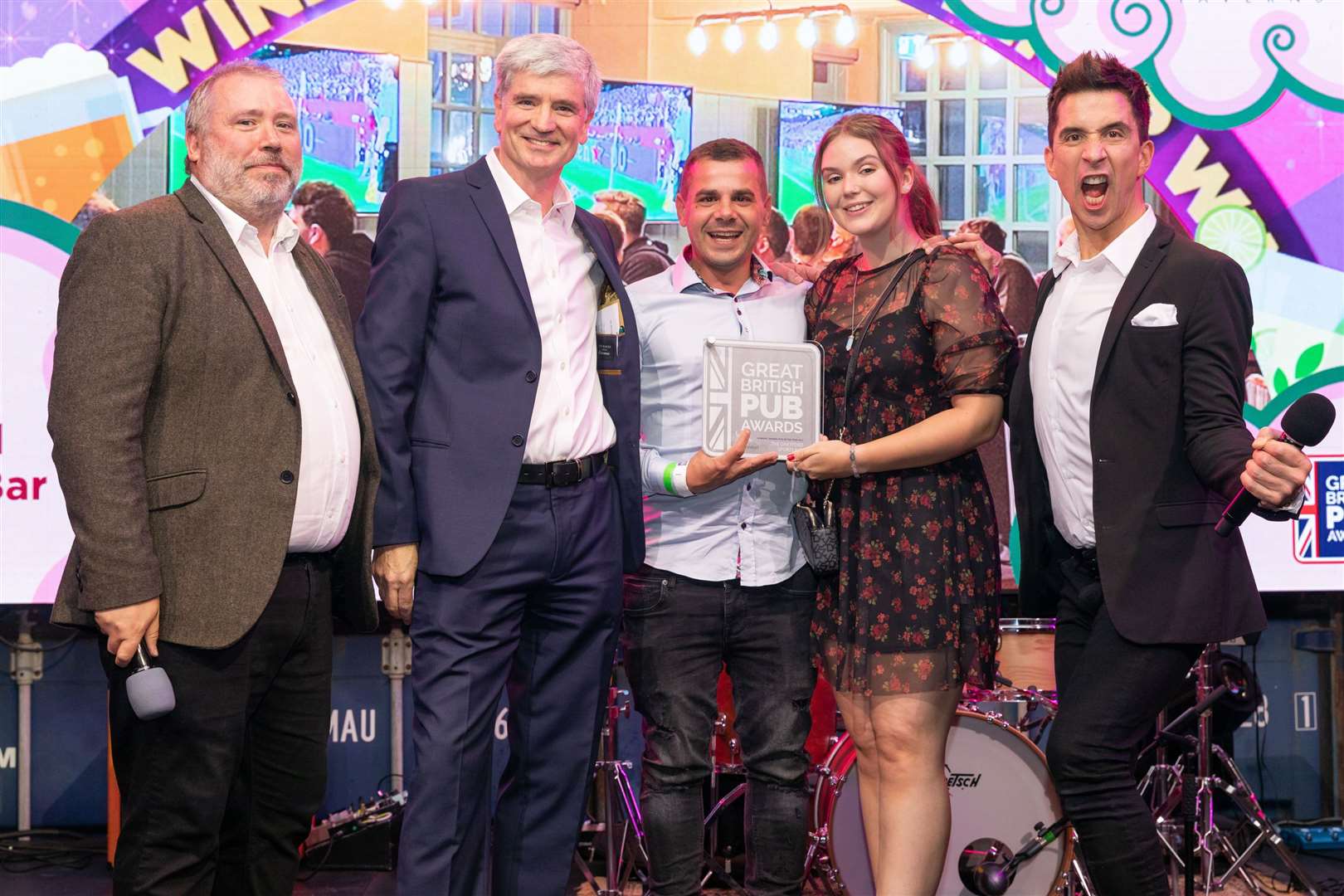 Dartford Sports Bar won Admiral Pub of the Year at the Great British Pub Awards, pictured with comedian Russell Kane