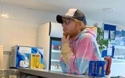 Ed Sheeran pondering over his fish and chips order... he ended up opting for scampi and a jumbo sausage. Pic: Greatstone Fish Bar