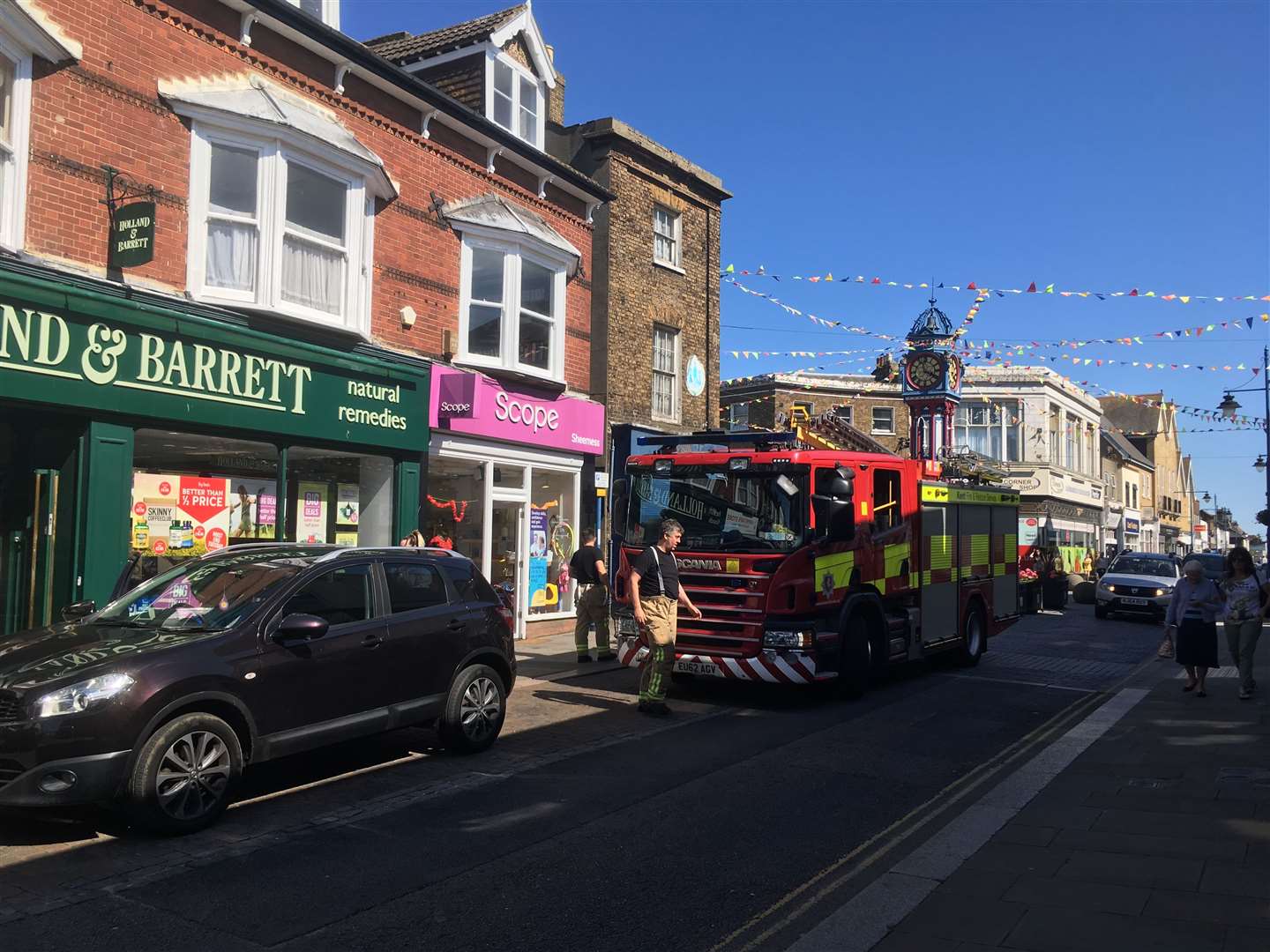 Firefighters outside Holland & Barrett shop in Sheerness High Street (13368380)