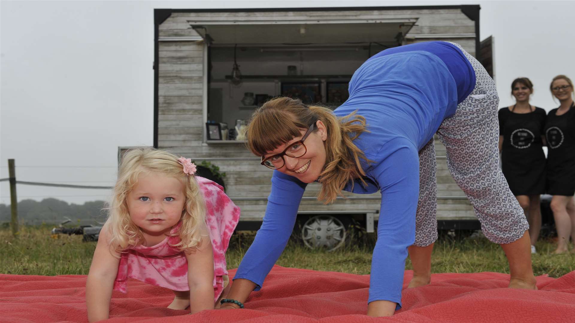 Three year old Orlagh and Carly Allen try some early morning Yoga at Beyond The Pale