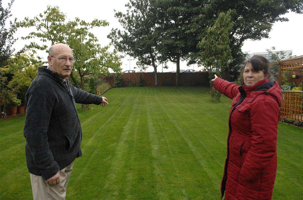 David Williams and Dee Griffin point out the car park and access road which overlooks their back gardens in Minster Road