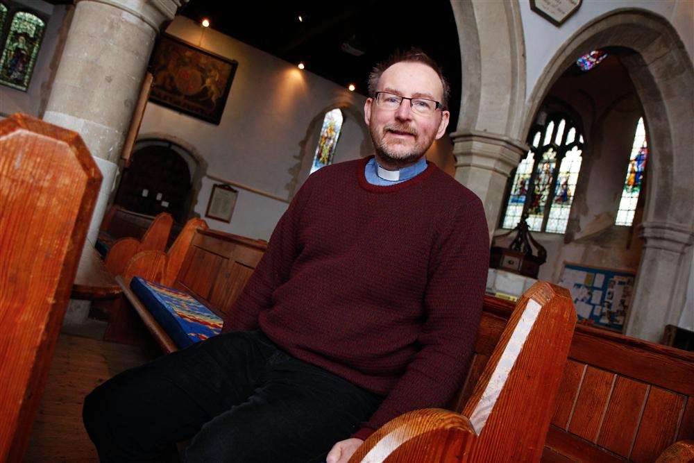 The Rev Tim Hall with the pews that are being sold from Minster Abbey