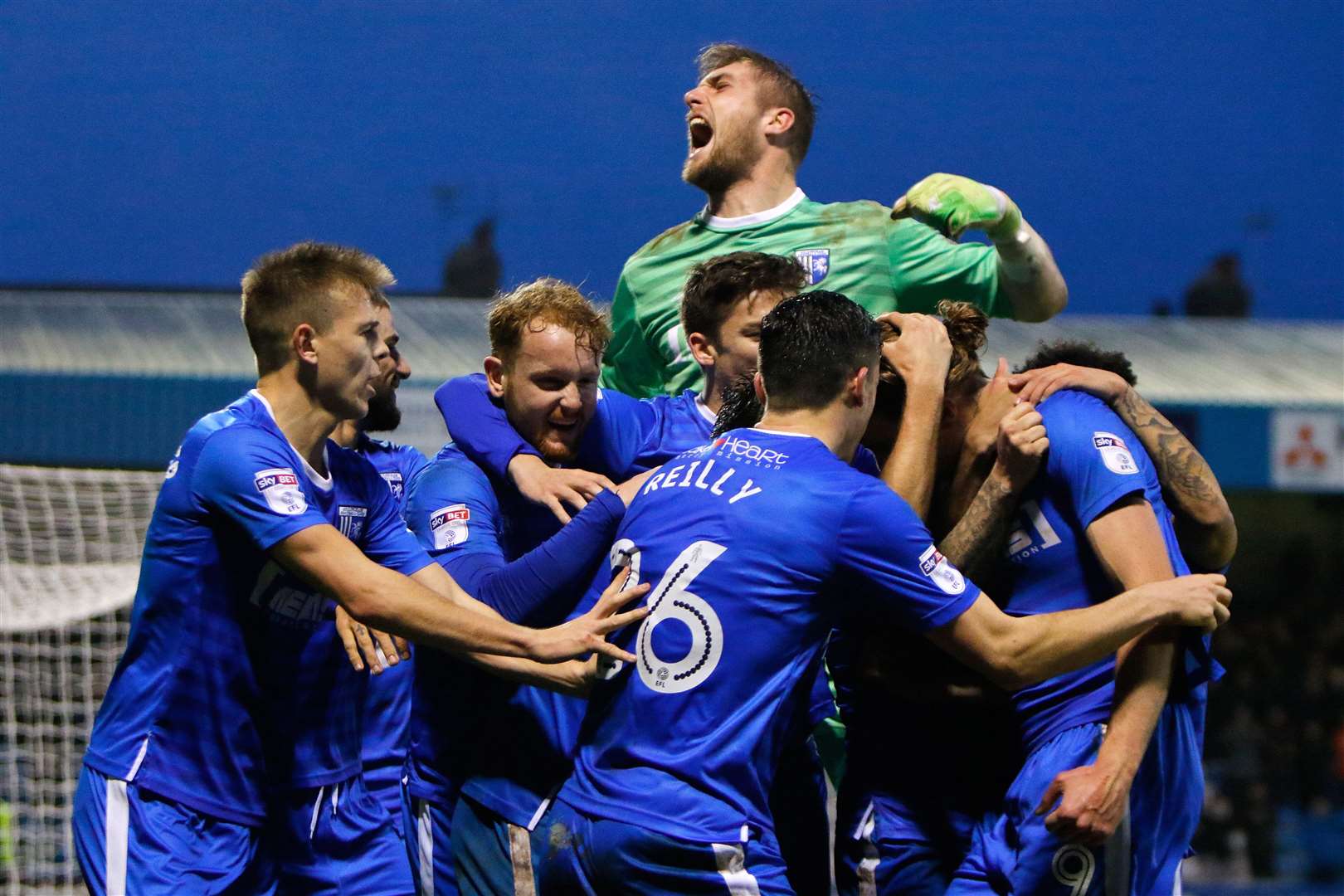 Gillingham mob Tom Eaves after he scores the late winner against Fleetwood Picture: Andy Jones