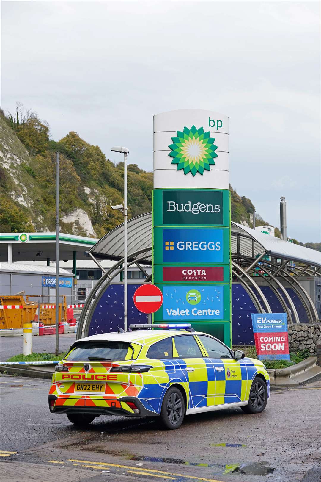 A police car at a petrol station near the migrant processing centre in Dover, Kent, following the incident. Picture: PA