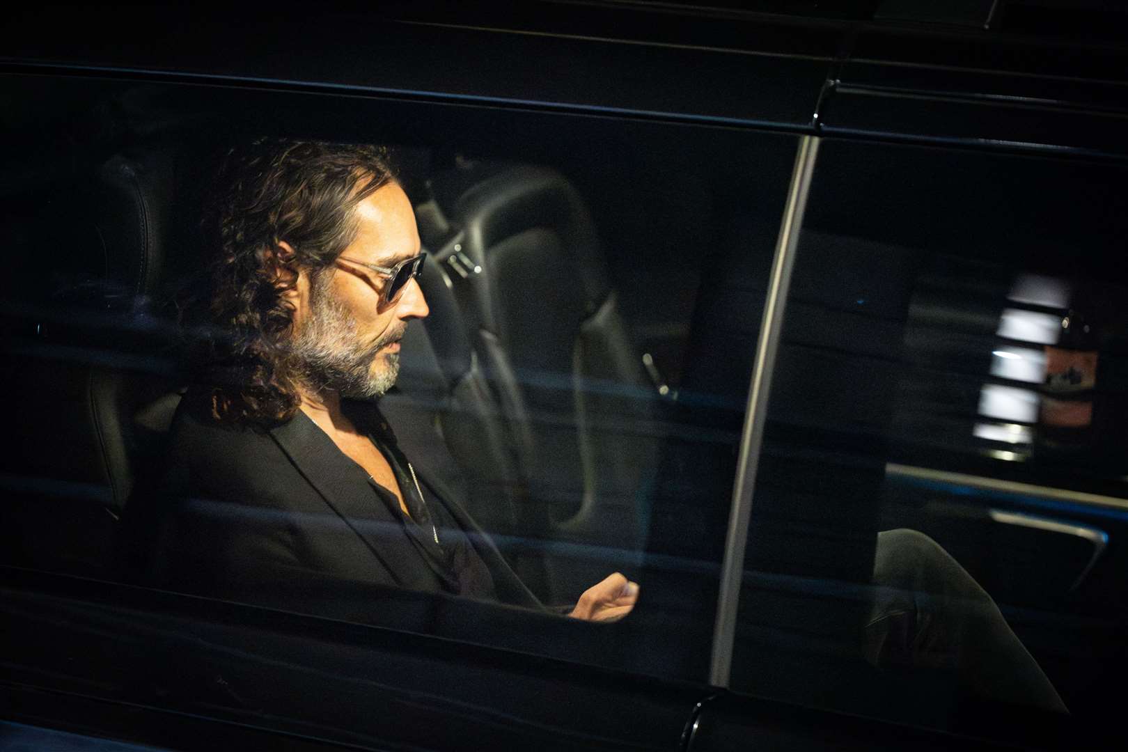 Russell Brand leaves the Troubadour Wembley Park theatre in north-west London after performing a comedy set as he faces allegations of sexual assault (James Manning/PA)