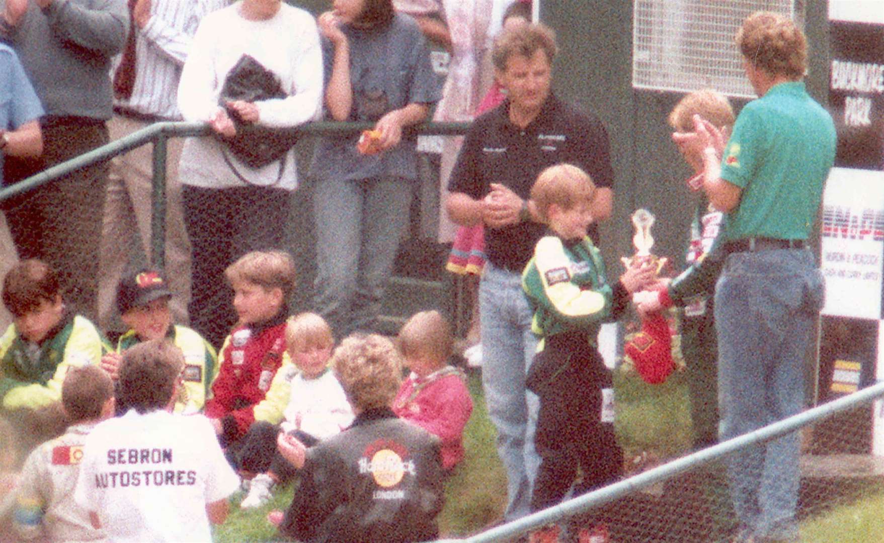 Prince Harry was delighted to be presented with a trophy by Johnny Herbert at Buckmore during his second visit to the circuit in 1993. He was applauded by his brother, Prince William, and his mother, the Princess of Wales, who is seen here with her back to the camera