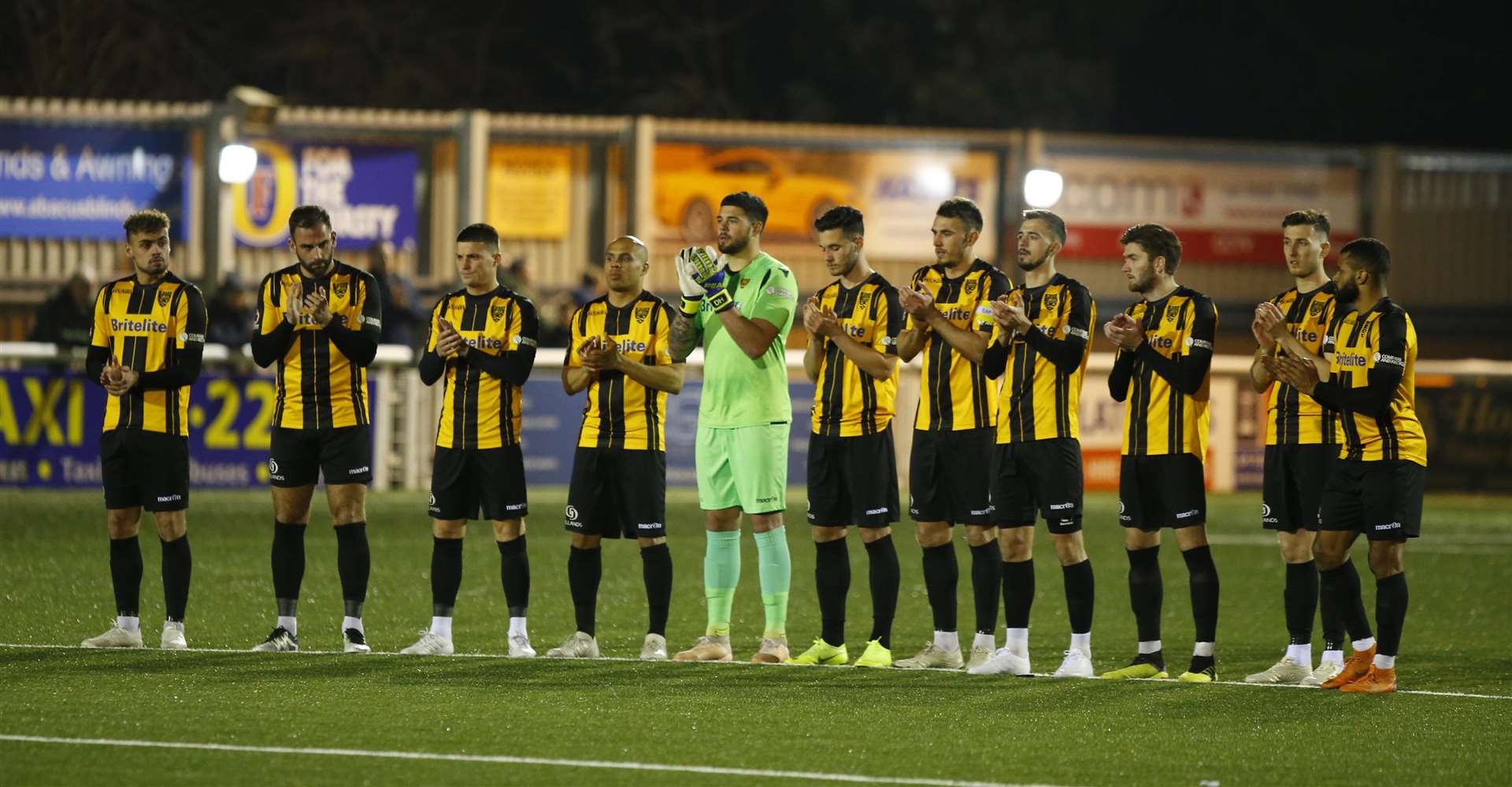 Maidstone players pay tribute to England 1966 hero Gordon Banks with a minute's applause before kick-off Picture: Andy Jones