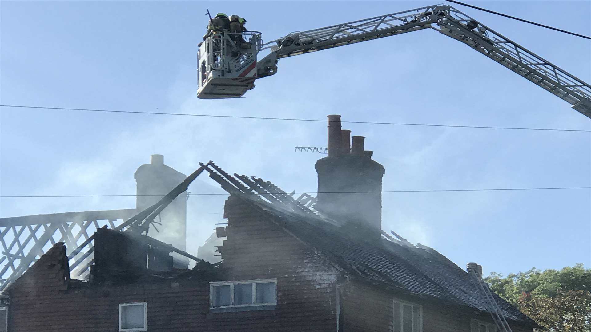 Fire crews have used an aerial ladder to reach the blaze. Picture: James Bal