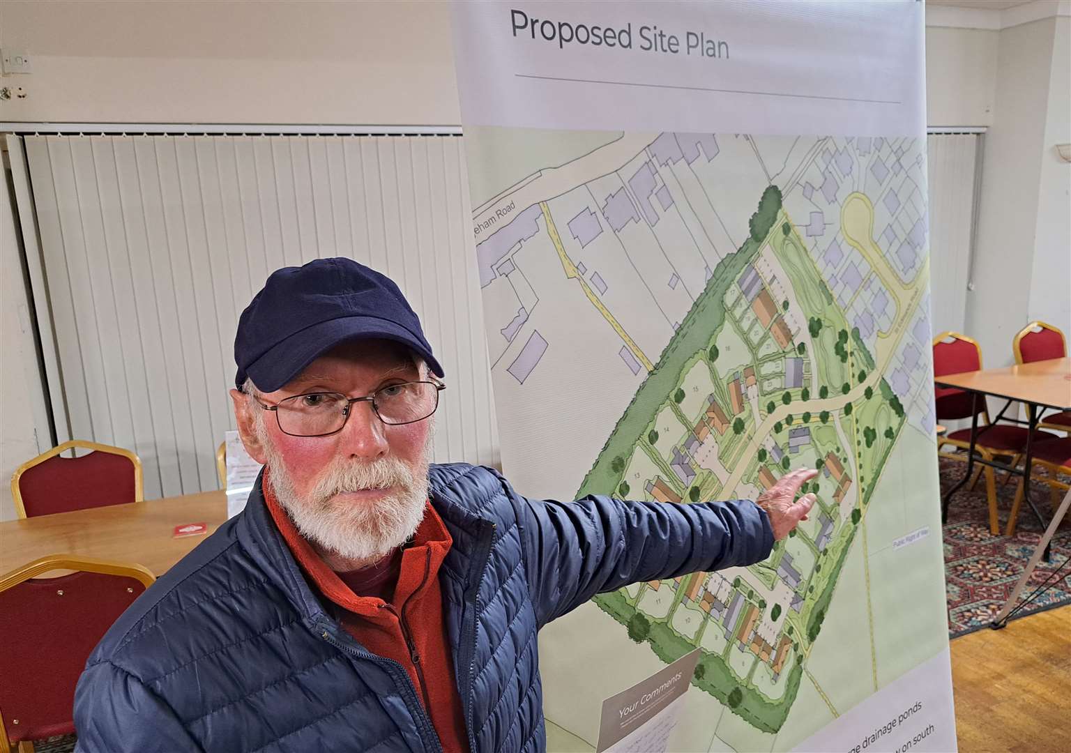 Neighbour Tony Timperley viewing the development plan for St Edmunds Road, Great Mongeham, Deal