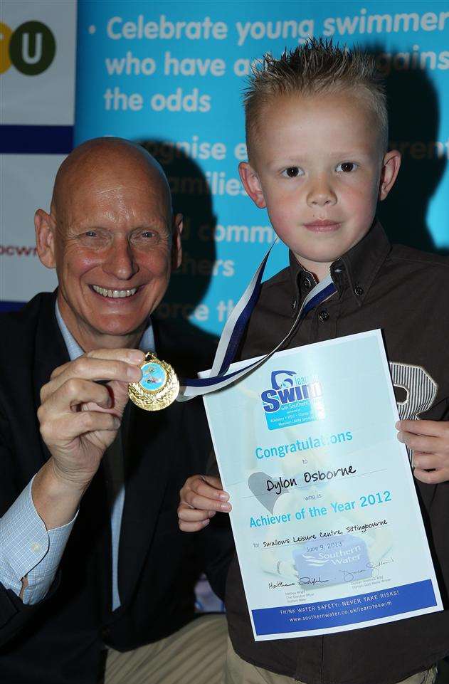 Gold medalist Duncan Goodhew presents Dylon Osborne with his medal after he won an Achiever of the Year award