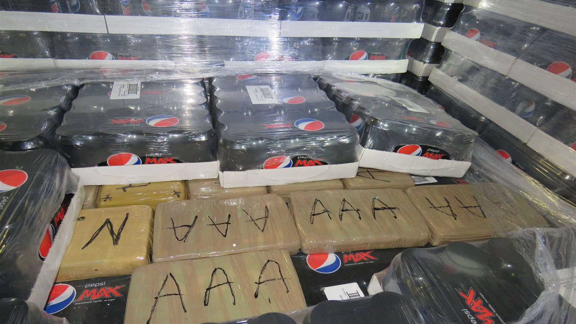 The seized cocaine packages hidden with soft drinks.