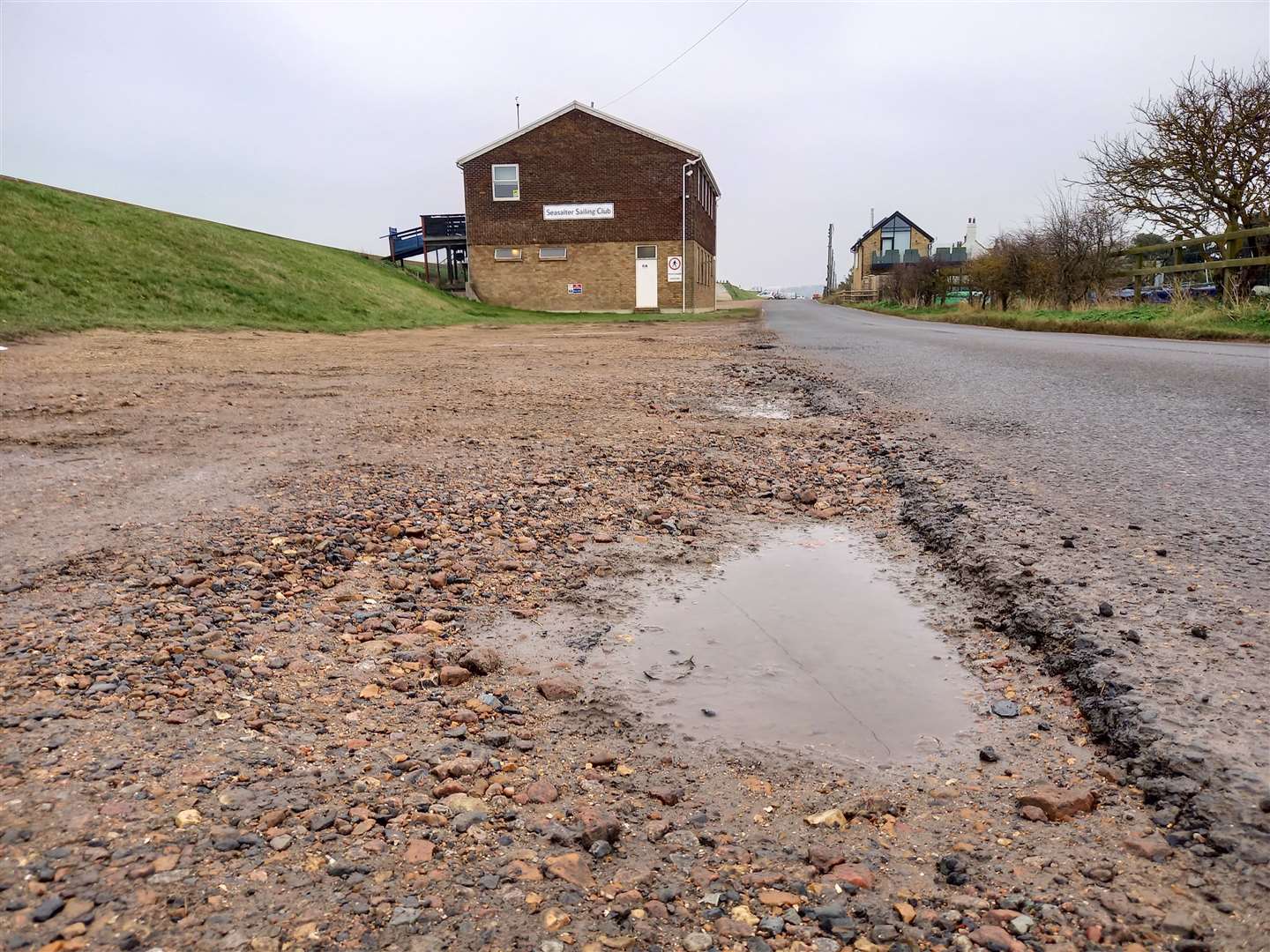 The car park is full of potholes and deep puddles