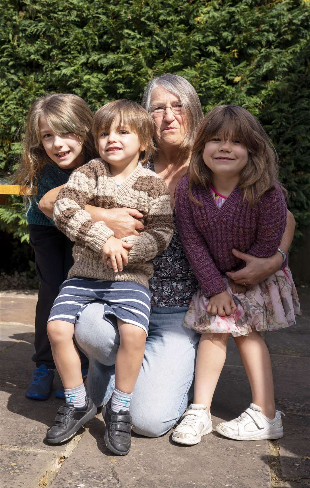Susan reunited with her grandchildren, Emily (left), Benjamin (second left) and Daisy (right) (Giles Anderson/PA)