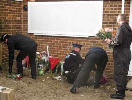 Police place floral tributes at 50 Irvine Drive, Margate. The house has now been boarded up. Picture: KIM SANDERS