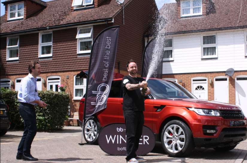 Will Hindmarch, CEO of BOTB celebrates with Rikki Tronson after revealing that he has won the Range Rover Sport