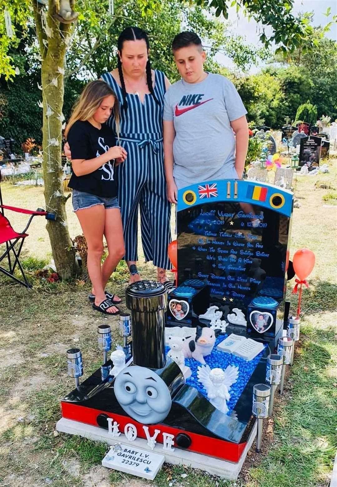 Laura Cooke with her children Archie and Macie by Luchii's grave