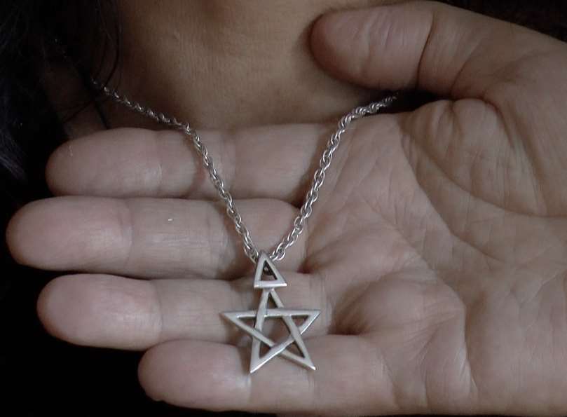 Both Mandy and Ian wear pentacles, a symbol of wiccan beliefs