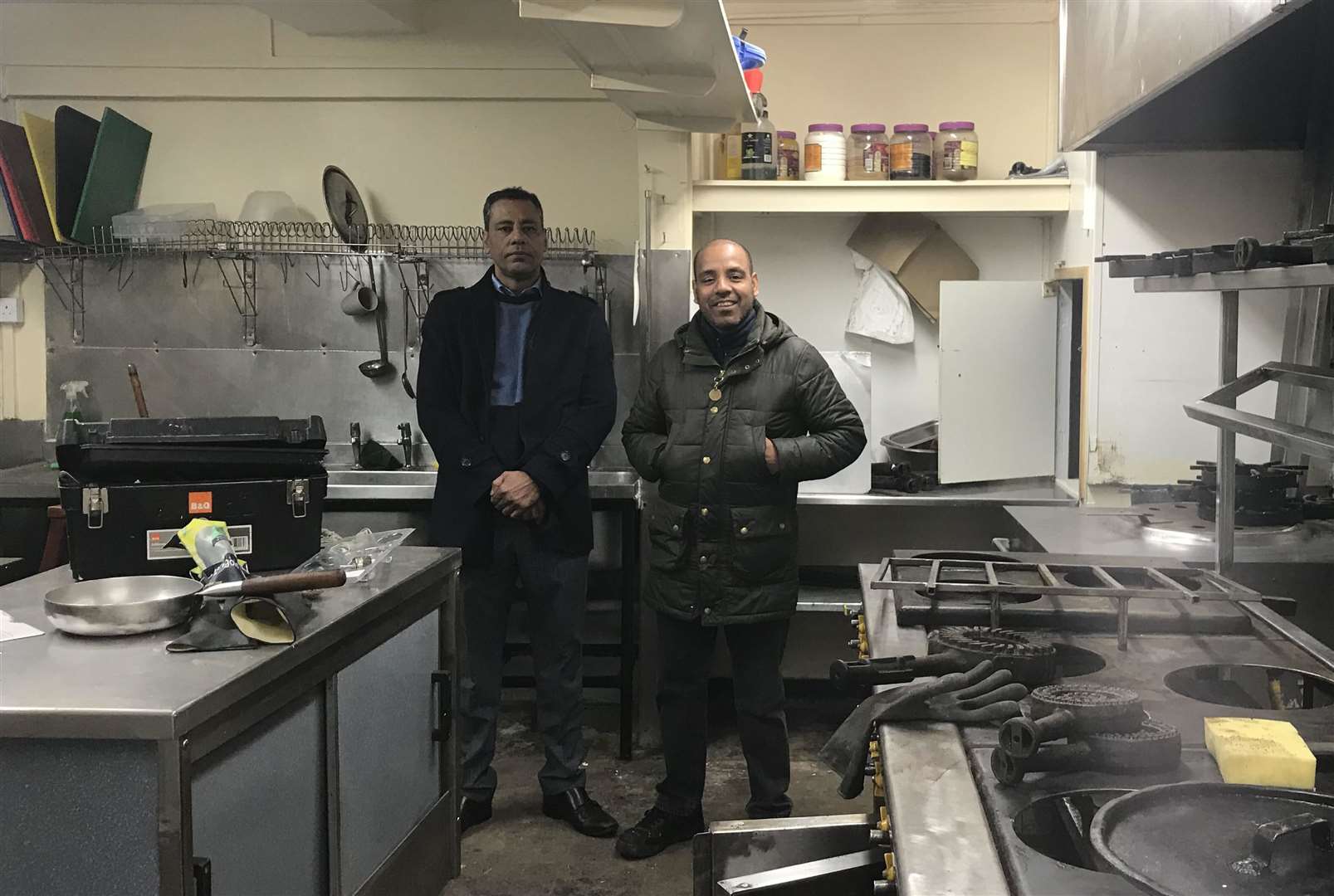 Shiper Karim, owner, and Shalim, manager, stand in their kitchen where the cockroaches lived and which is being extensively renovated