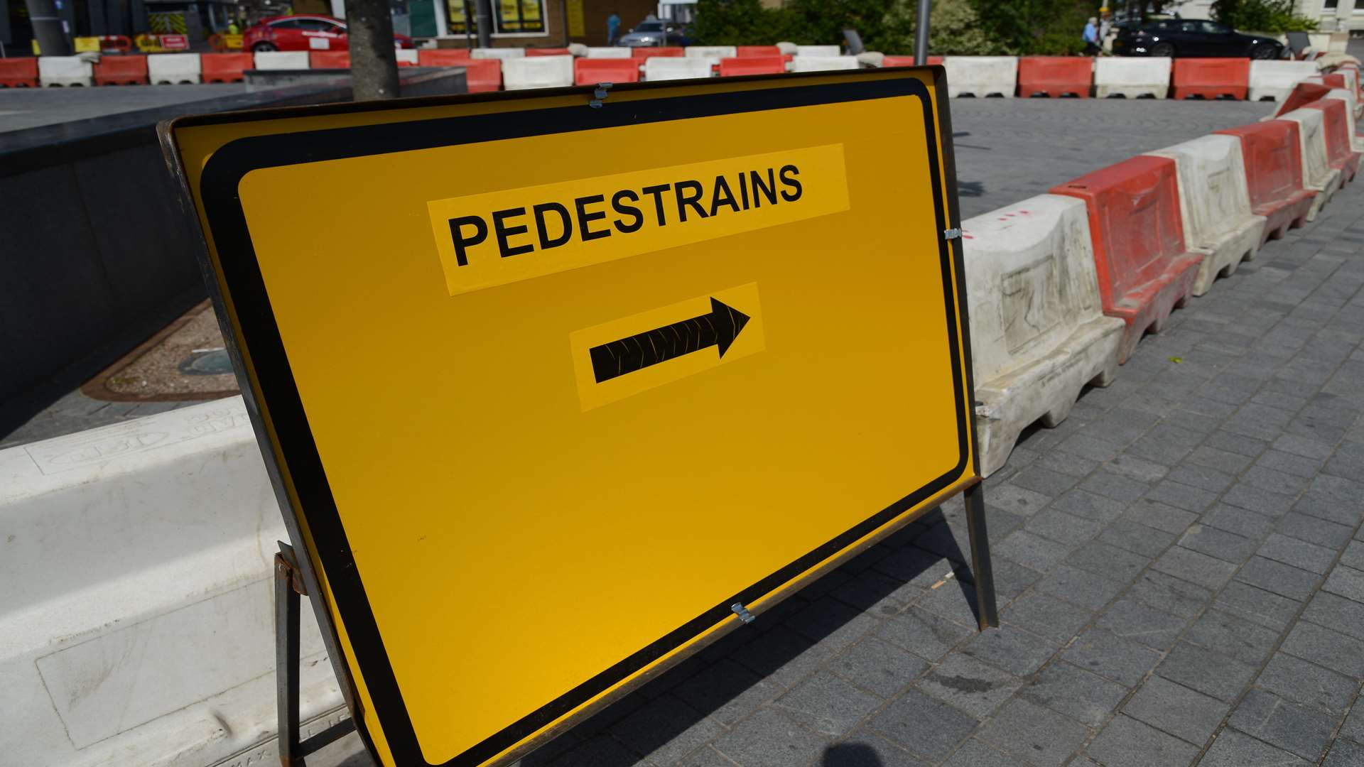 "Pedestrains" appears on a sign at the bottom of Bank Street