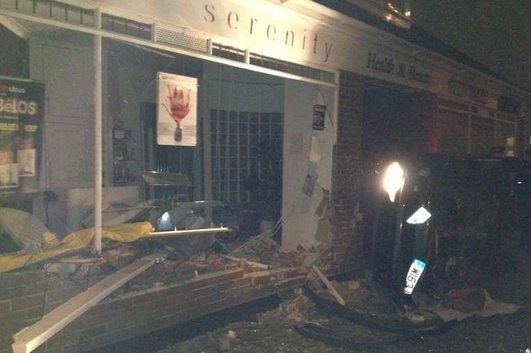 The Peugeot lies on its side after smashing into the Serenity beauty salon. Picture: Rebecca Nutt