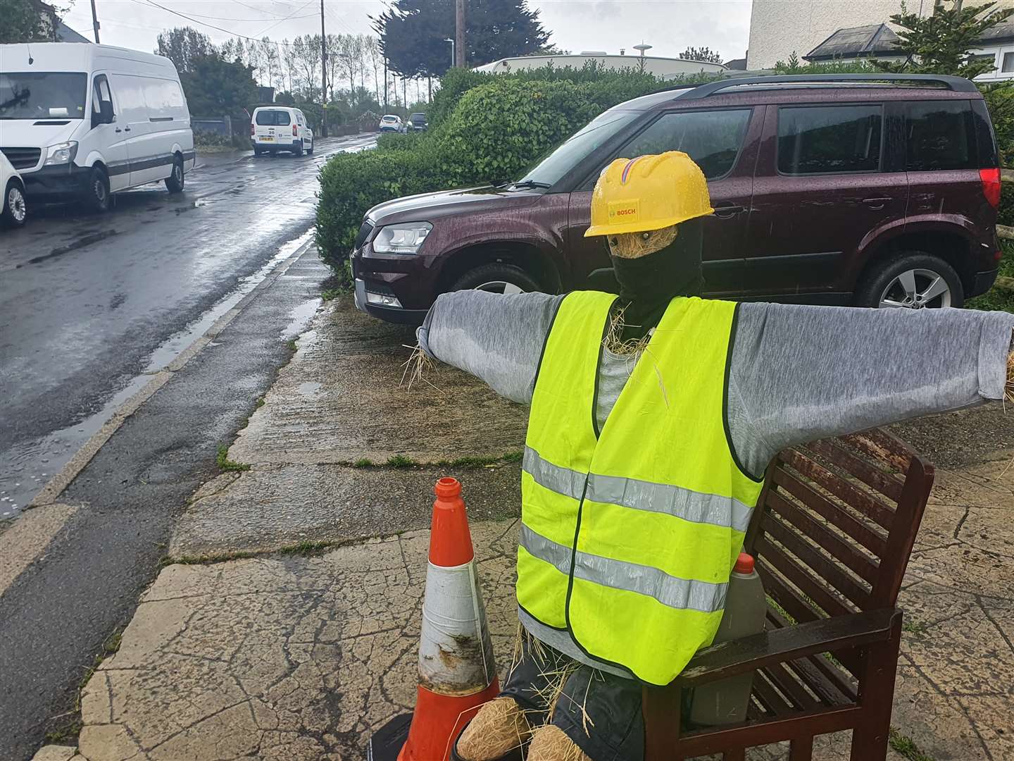 This scarecrow, complete with high-vis jacket and hard hat, keeps watch