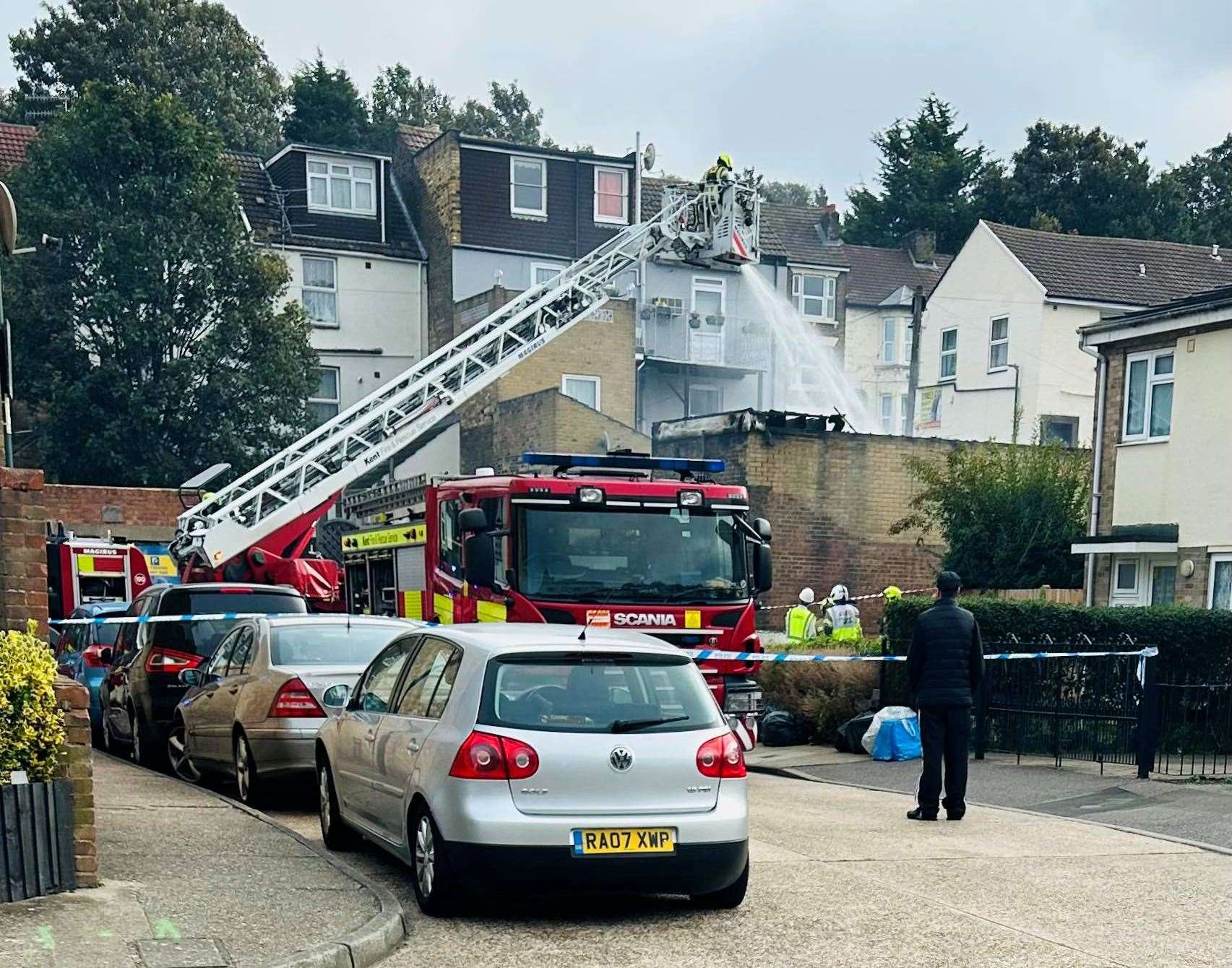 Fire crews were spraying water into the garage. Picture: Angela Louise Fox