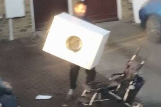 A man caught on camera loading a washing machine on to a pushchair earlier this month.