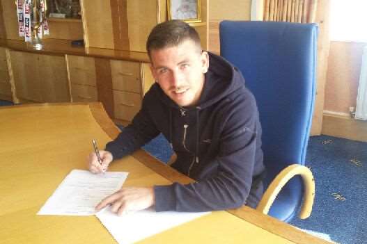 Cody McDonald signs his new deal at Priestfield. Picture: GFC