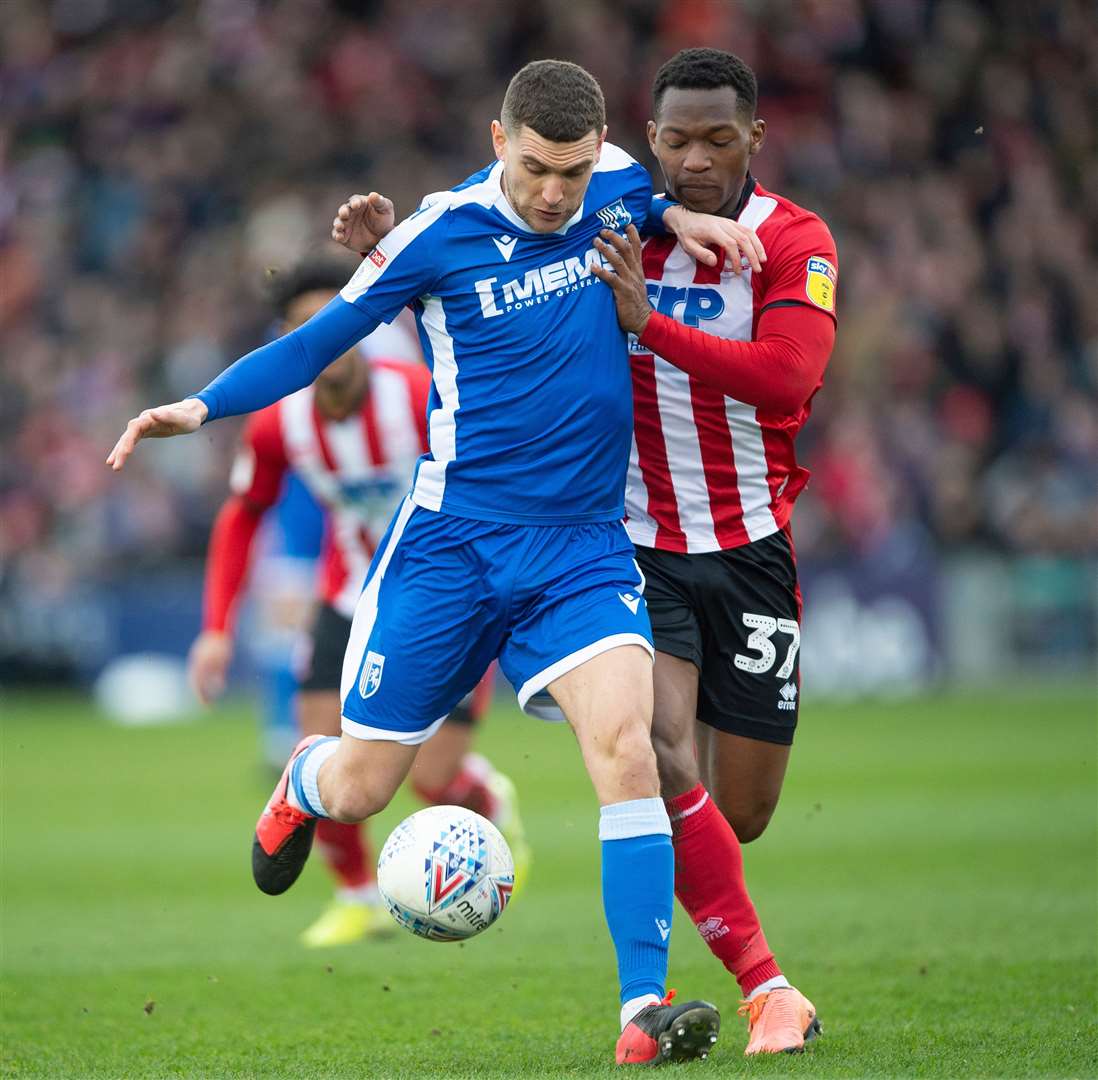 Stuart O’Keefe is challenged by Tayo Edun in Lincoln vs Gillingham game Picture: Ady Kerry/AK pictures
