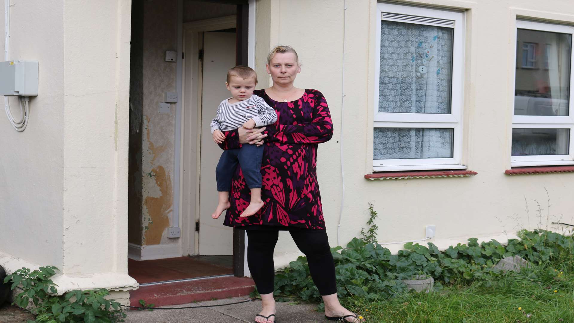 Sinead De Lobel and her two-year-old Callum outside their home in Dickens Road, Gravesend