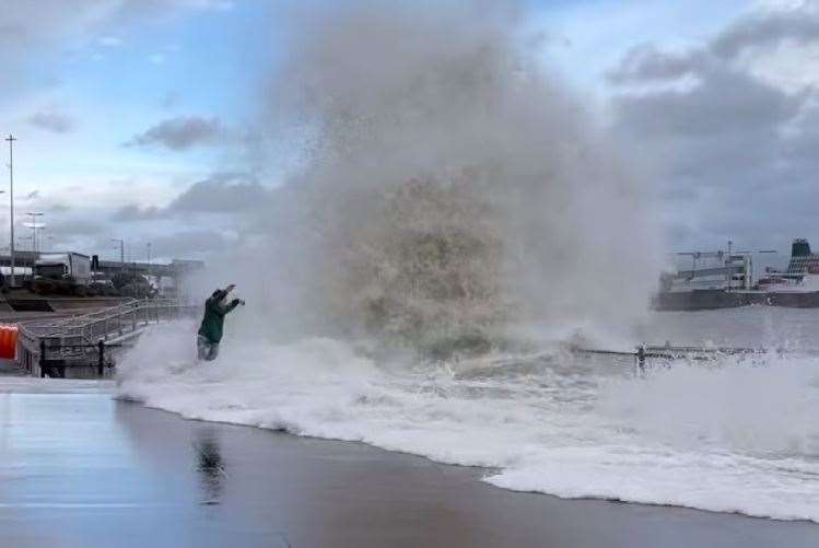 The man is still standing when the wave first hits on Dover seafront. Picture: Rebels Coffee Dover / @rebels_dover on Instagram