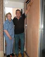 Ian Herbert with his wife, Rose, by the door that was smashed by the burglar. Picture: MIKE SMITH