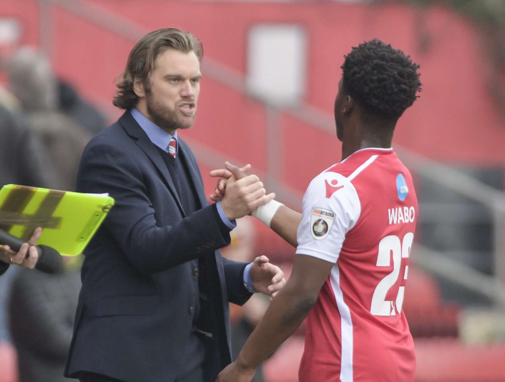 Norman Wabo gets a handshake from Ebbsfleet boss Daryl McMahon after making his debut against Maidenhead Picture: Andy Payton