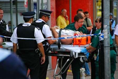 The injured officer is taken from the building on a stretcher. Picture by Nick Evans