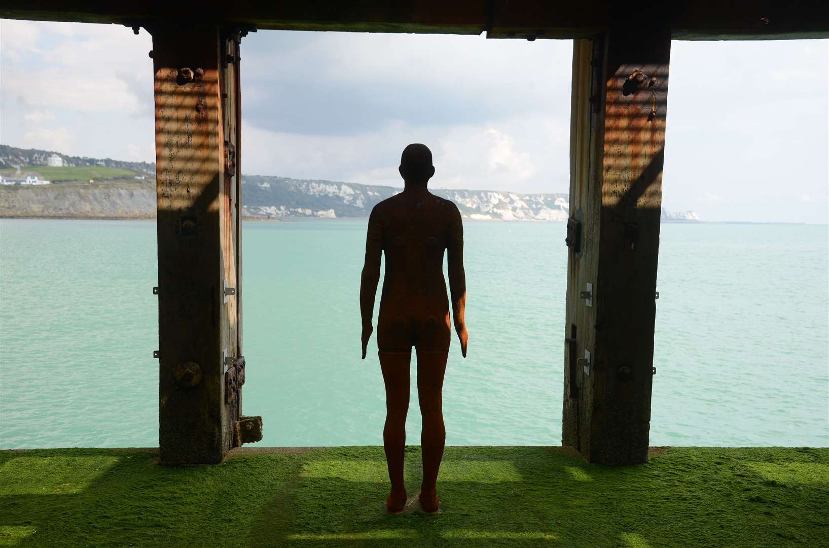 An Anthony Gormley statue looking towards the White Cliffs. Picture: Gary Browne