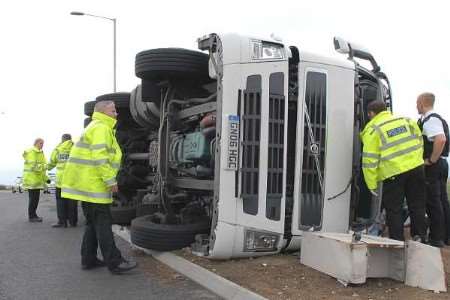 An overturned lorry on the roundabout between Cowstead Corner and Queenborough in August last year. Picture: MIKE SMITH