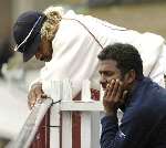 Sri Lankans Muthiah Muralitharan and Lasith Malinga discuss their luck on the players' balcony